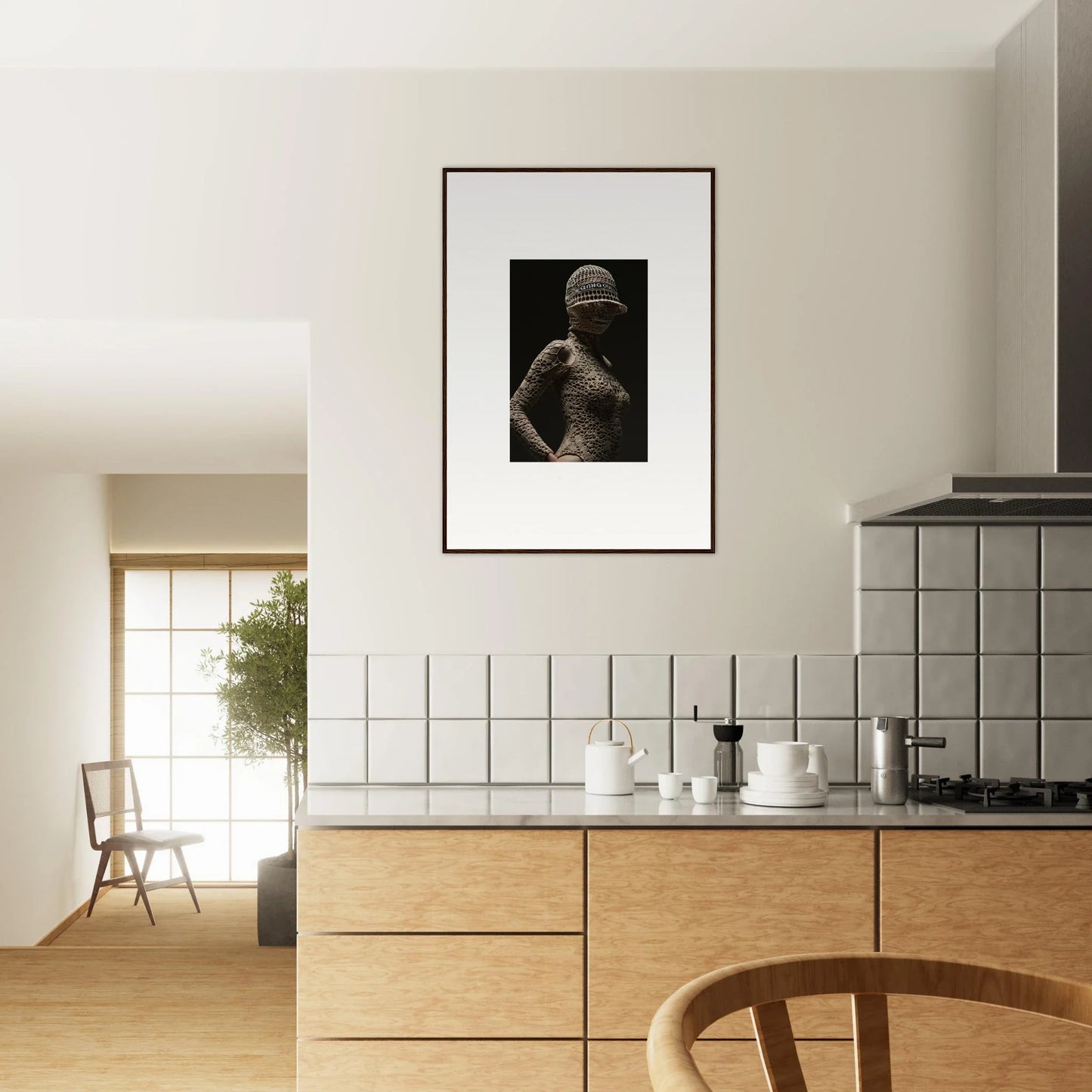 Modern kitchen with minimalist design featuring wooden cabinetry and a framed black-and-white photograph on the wall.