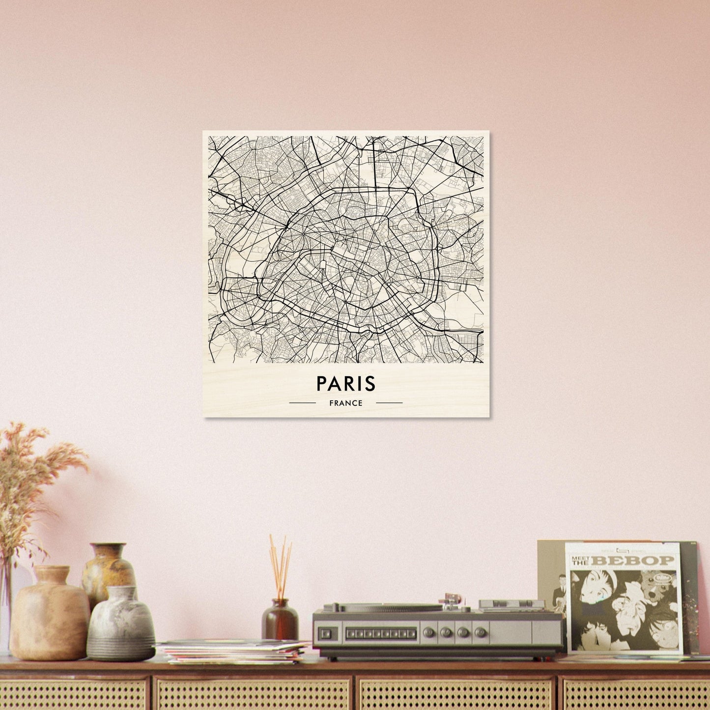 Map of Paris displayed as wall art above a shelf with decorative objects.