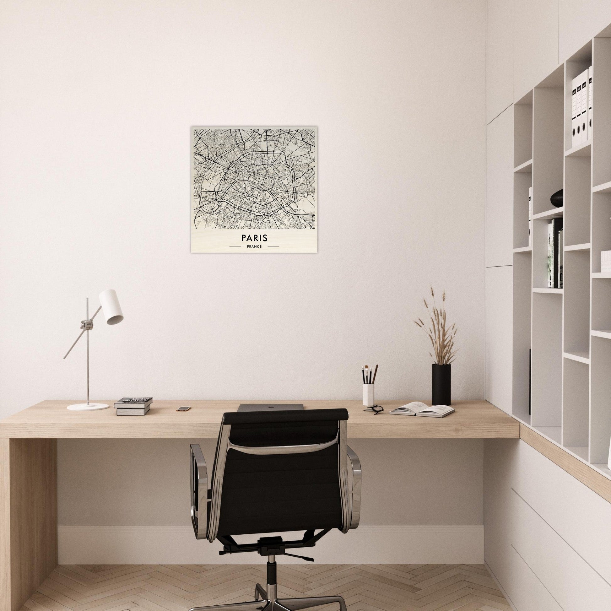 Minimalist wooden desk with a black office chair in a home workspace.