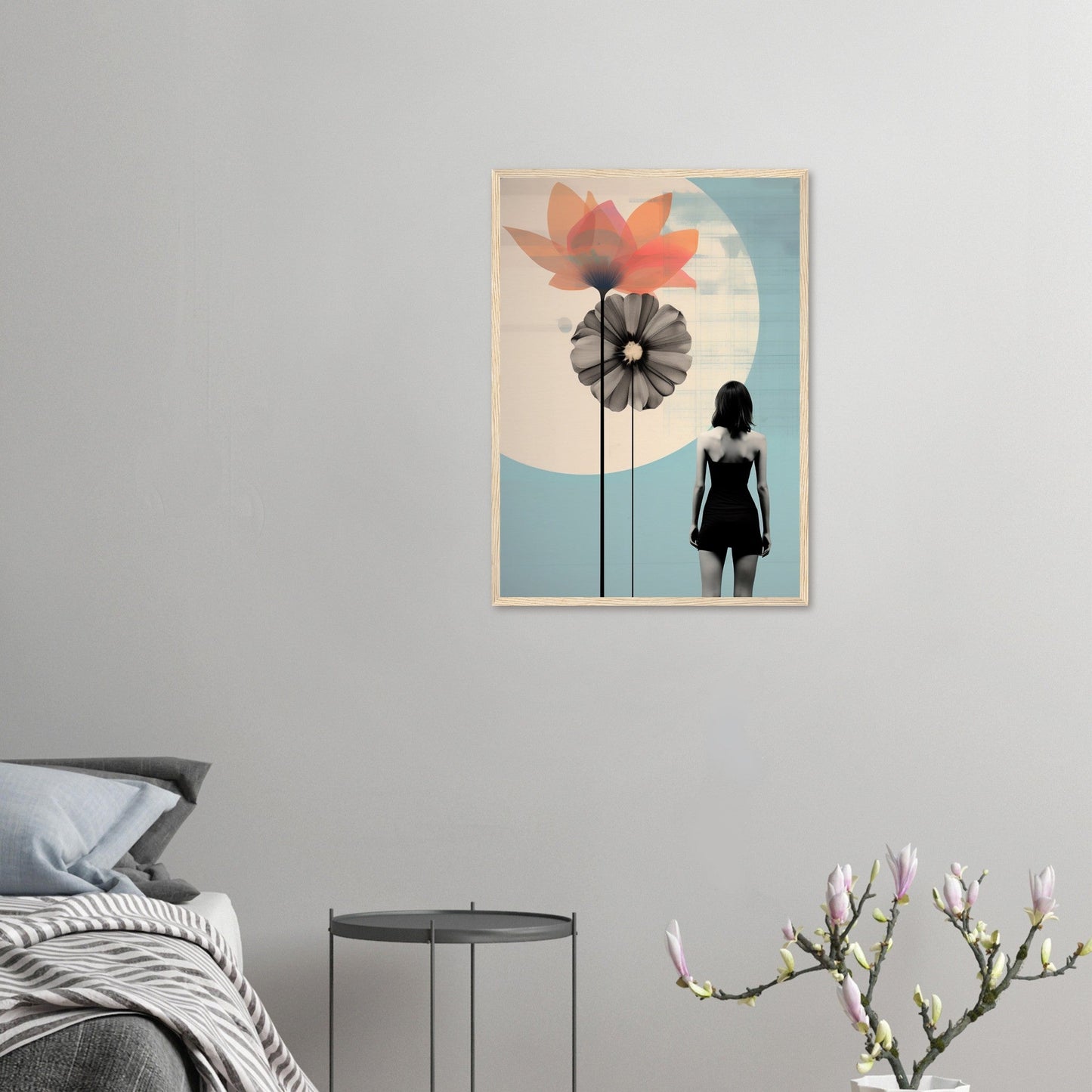 Framed artwork featuring a silhouette of a person standing near stylized flower shapes against a pastel background.