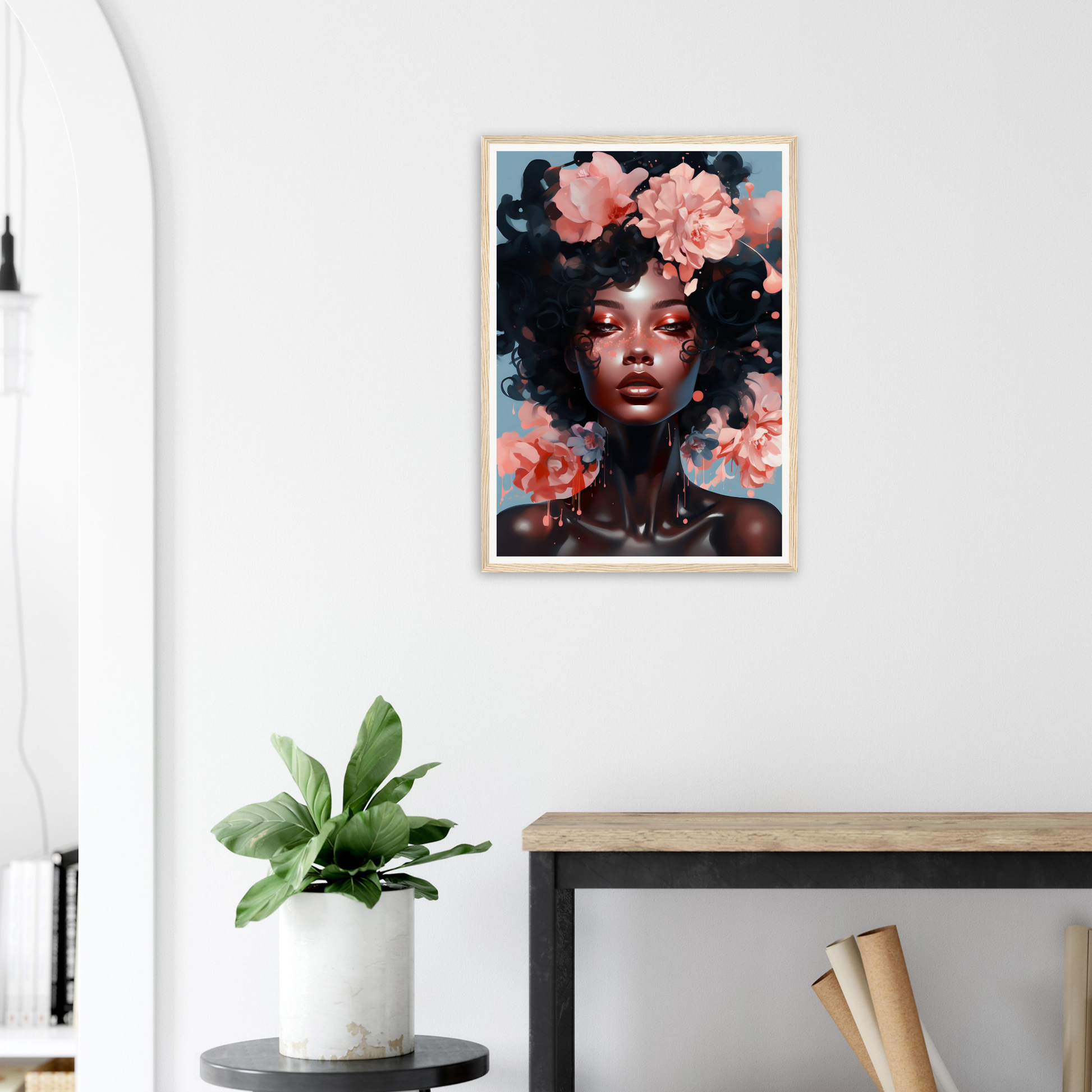 Framed portrait of a woman with an afro hairstyle adorned with pink flowers.