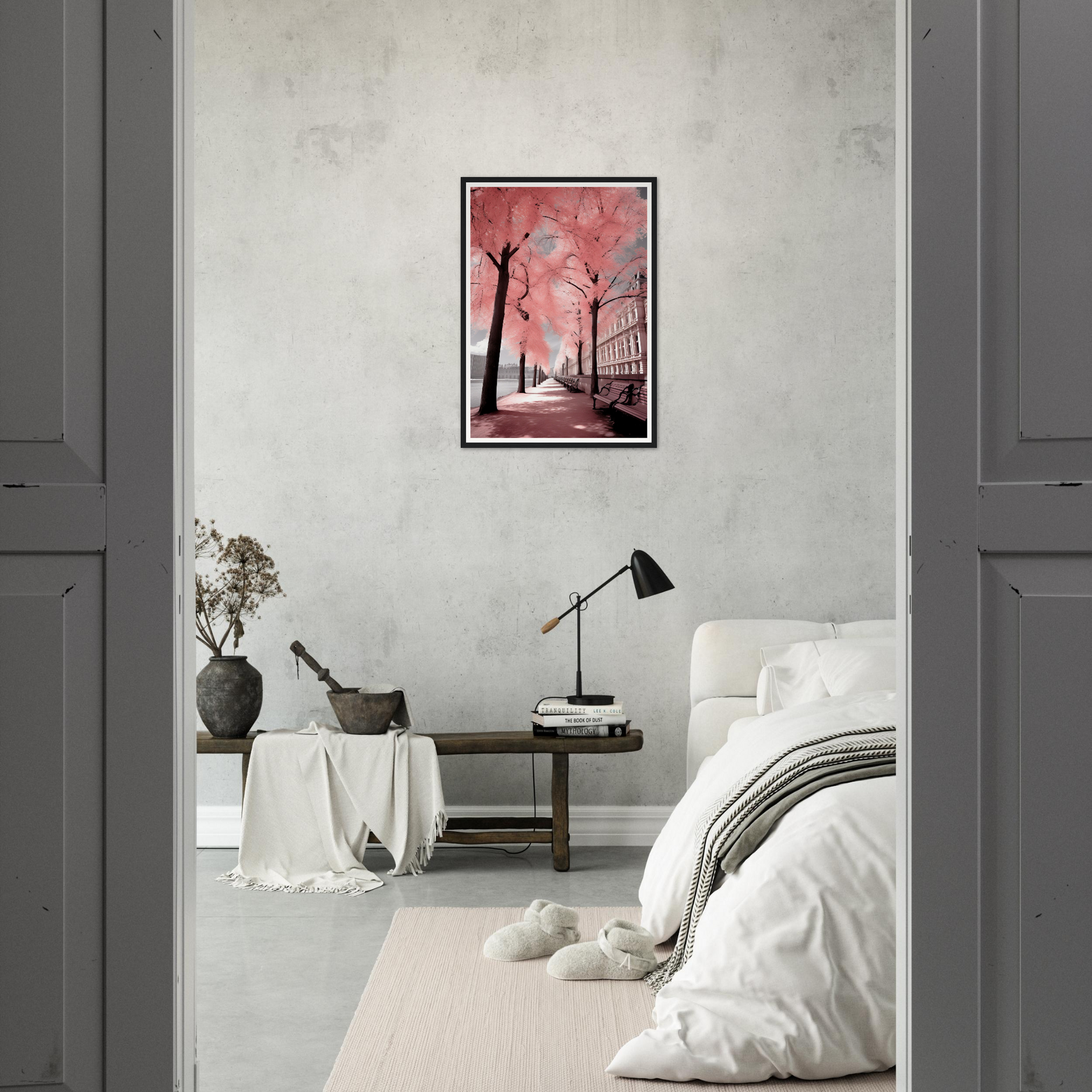 A pink and black painting hangs in a bedroom