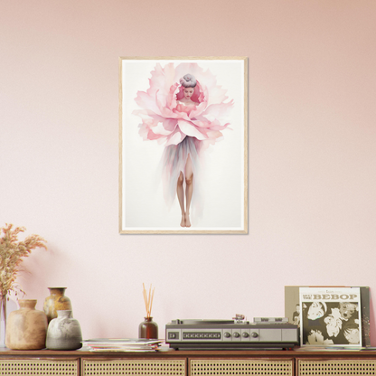 A pink flower in a frame on a wall