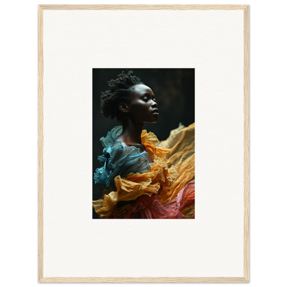 Portrait of a person with dark skin surrounded by vibrant, flowing fabric in teal, orange, and red hues.