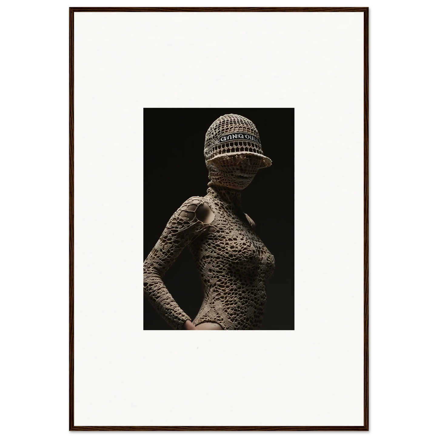 Sculptural figure with textured skin and a knitted cap.