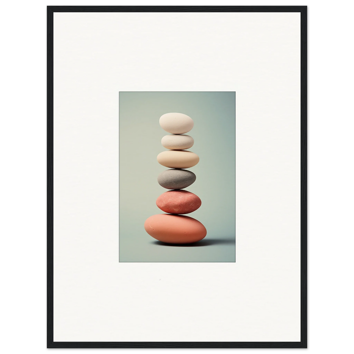 Stack of smooth stones in white, gray, and coral for room decor or canvas prints