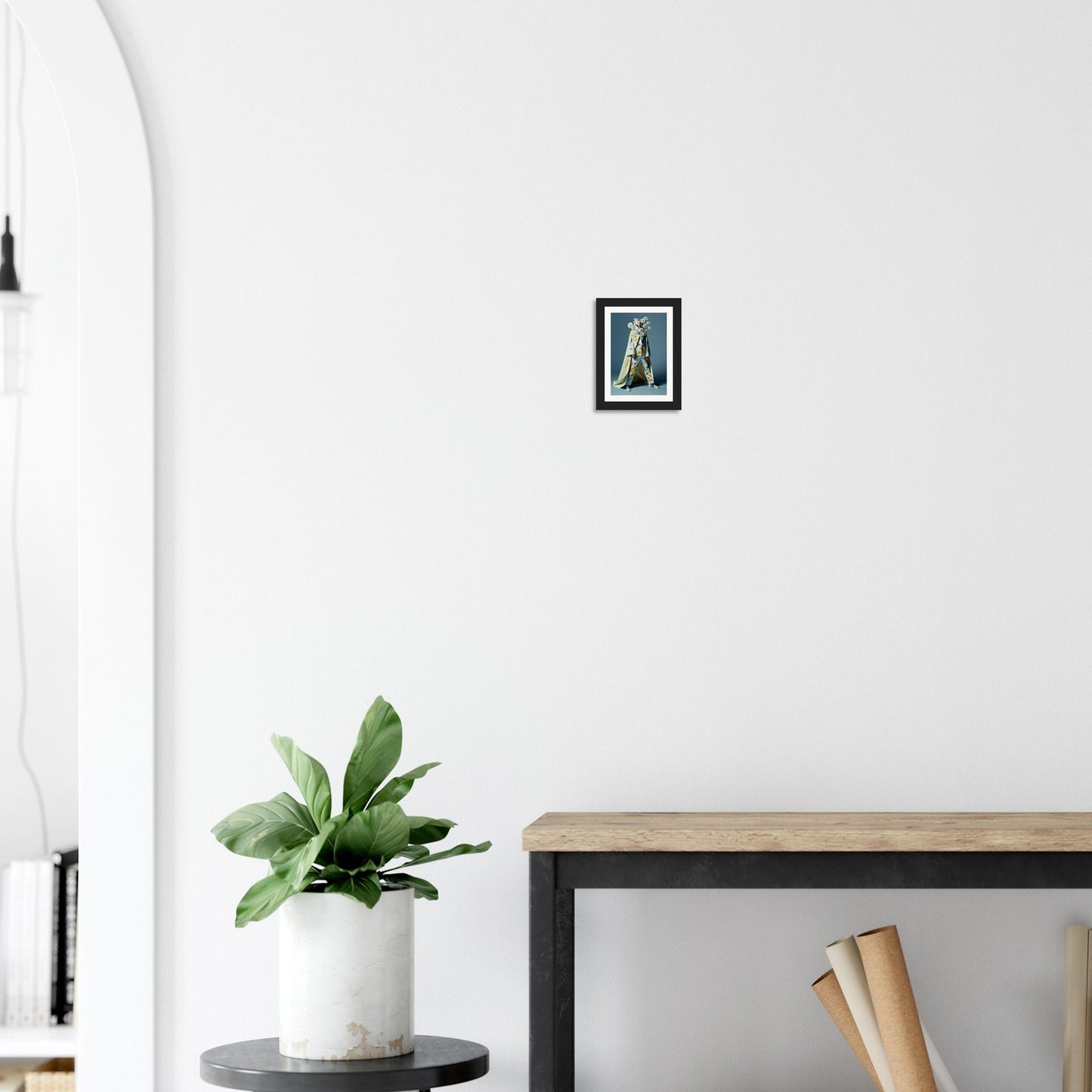 Framed artwork depicting the Eiffel Tower hanging on a white wall.