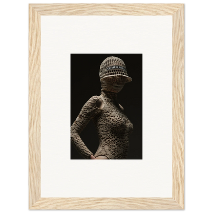 Textured sculpture of a female figure wearing a patterned cap.