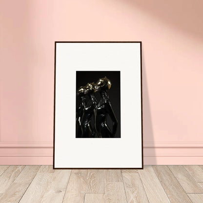 Framed black and white photograph of two metallic robotic figures standing close together.