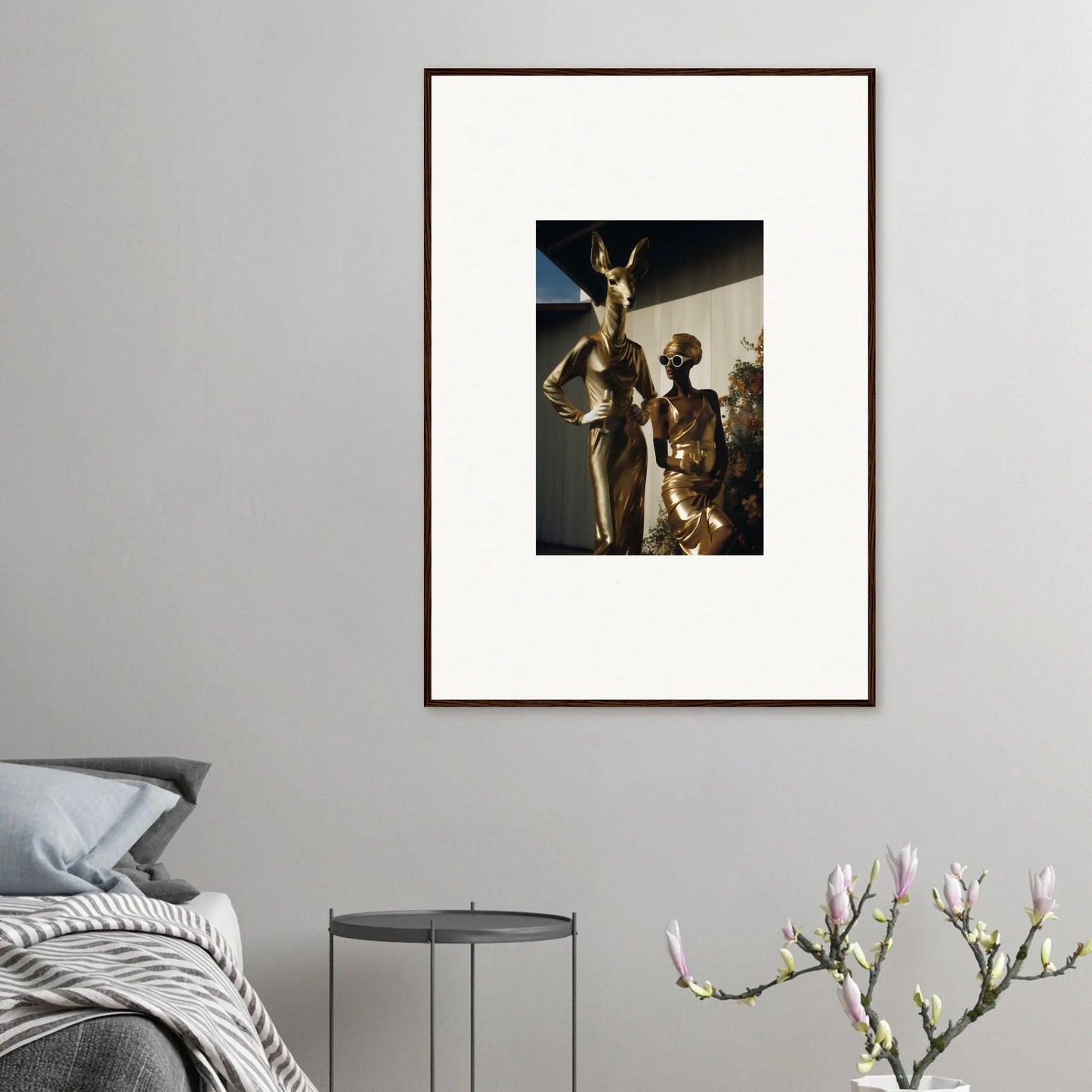 Framed artwork depicting ancient Egyptian-style figures against a dark background.