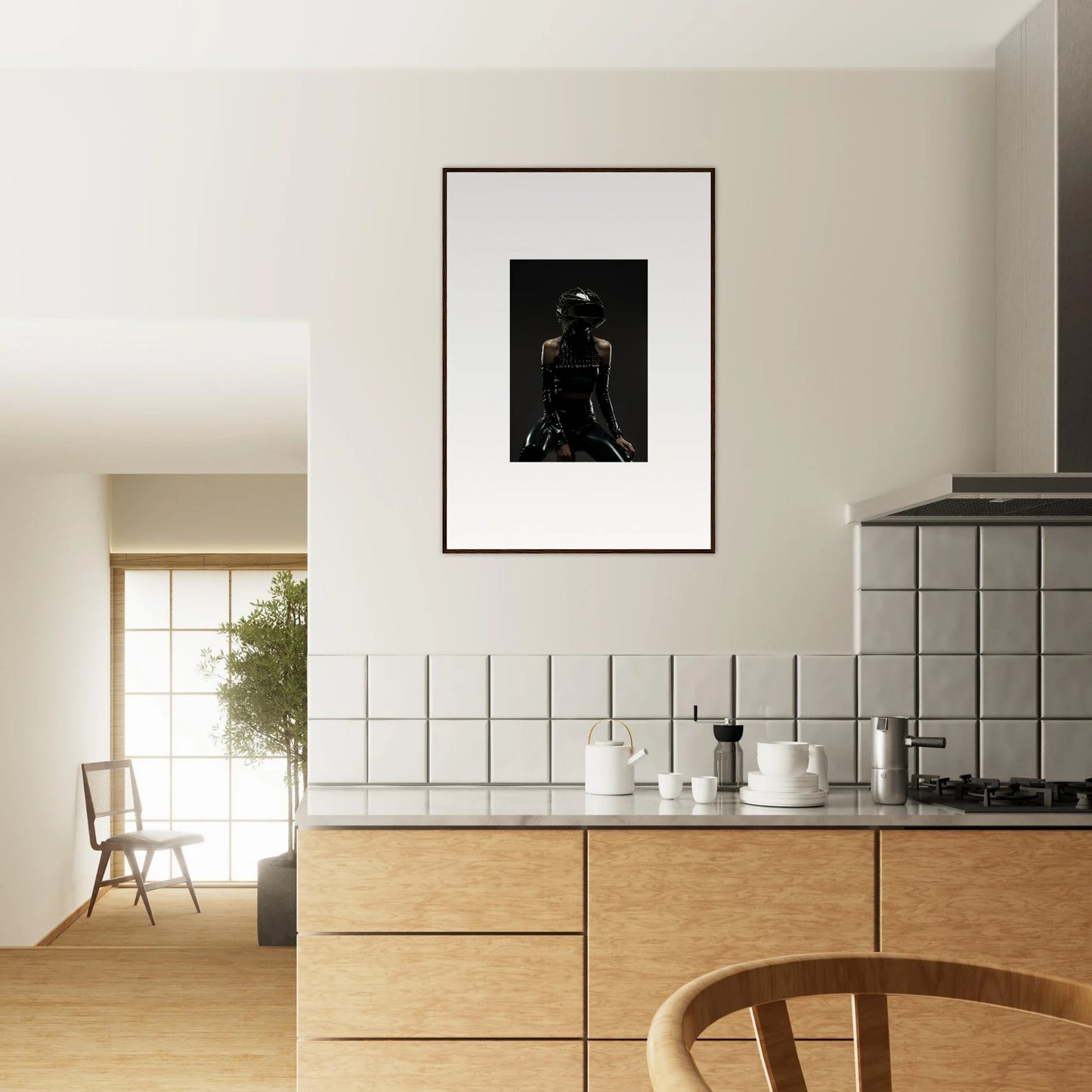 Modern kitchen with minimalist design featuring wooden cabinetry and a framed black and white photograph on the wall.