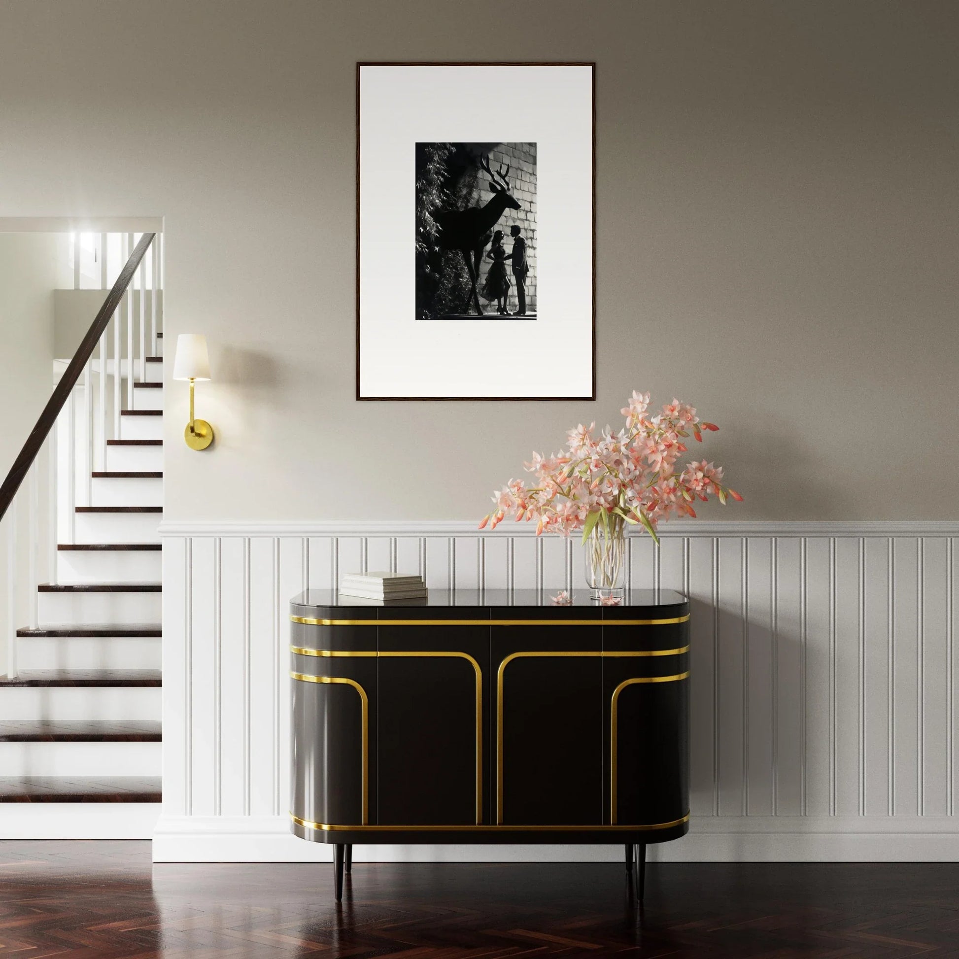 Elegant black and gold sideboard with curved edges beneath a framed artwork and floral arrangement.