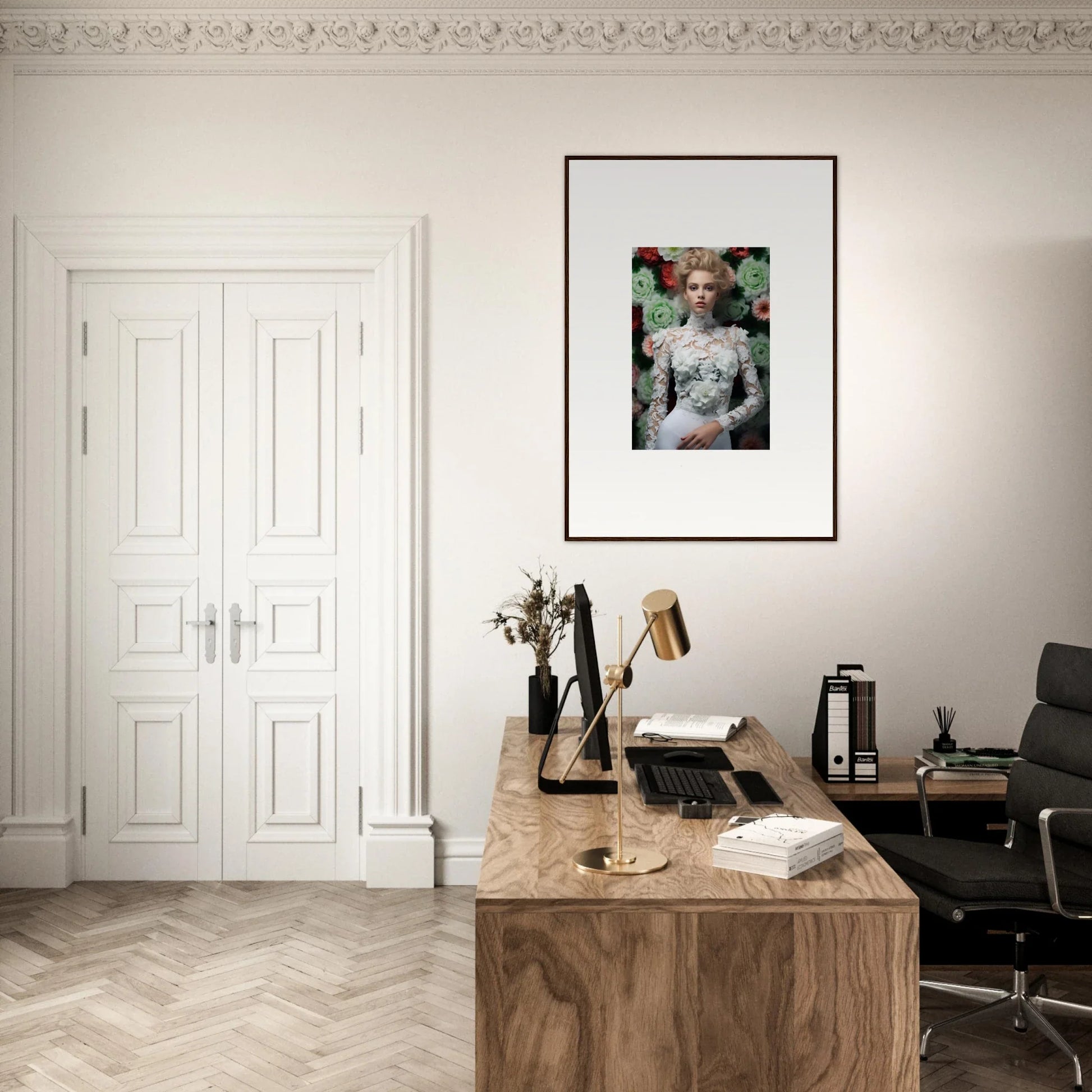 Home office workspace with a wooden desk, office chair, and framed artwork on the wall.