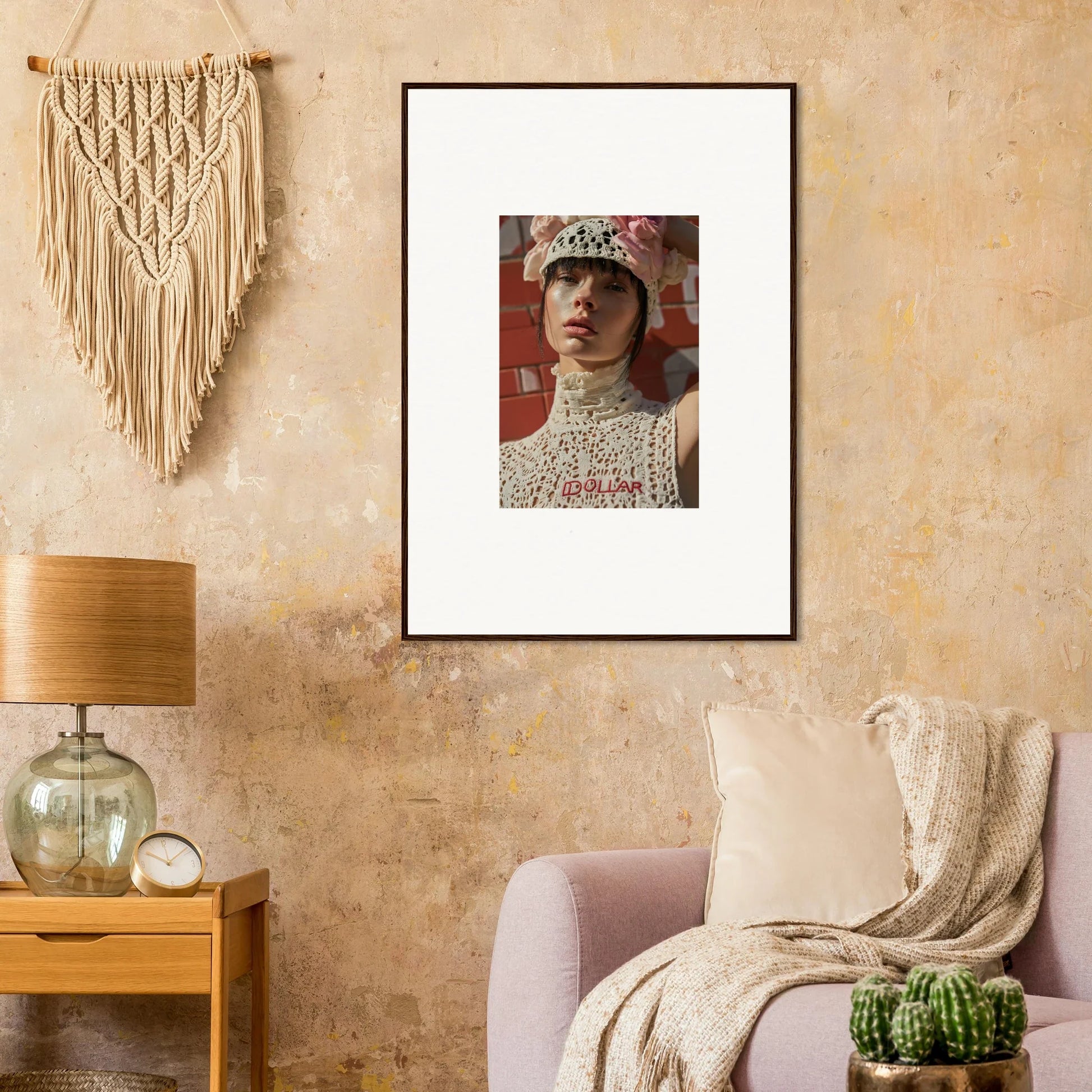 Framed portrait of a person wearing a crown and high-necked lace garment.