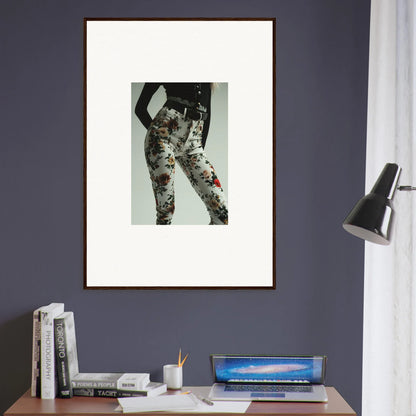 Framed artwork depicting a person’s lower body wearing patterned pants.