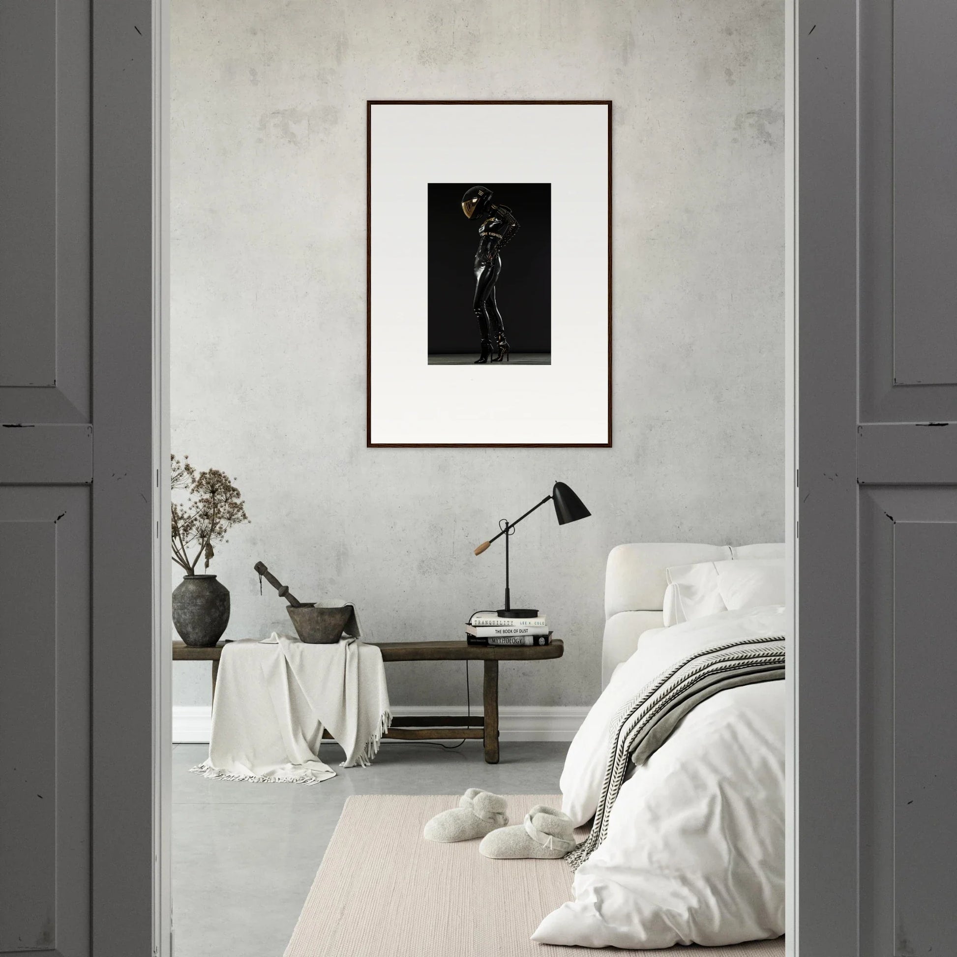 Minimalist bedroom with a framed black and white artwork as the focal point.