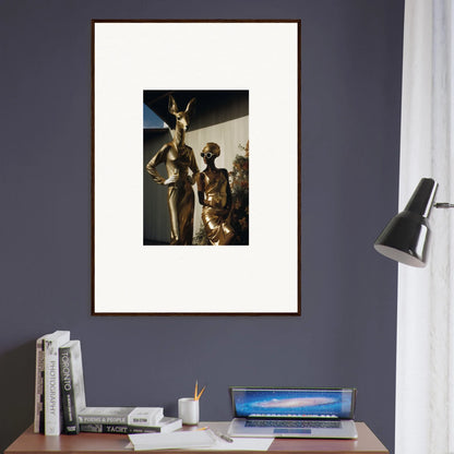 Framed artwork depicting sculpted figures in a dramatic pose against a dark background.