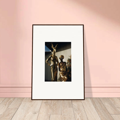 Framed photograph of bronze sculptures depicting human figures in dynamic poses.