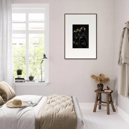 Bright, minimalist bedroom with white bedding and a framed black and white artwork on the wall.