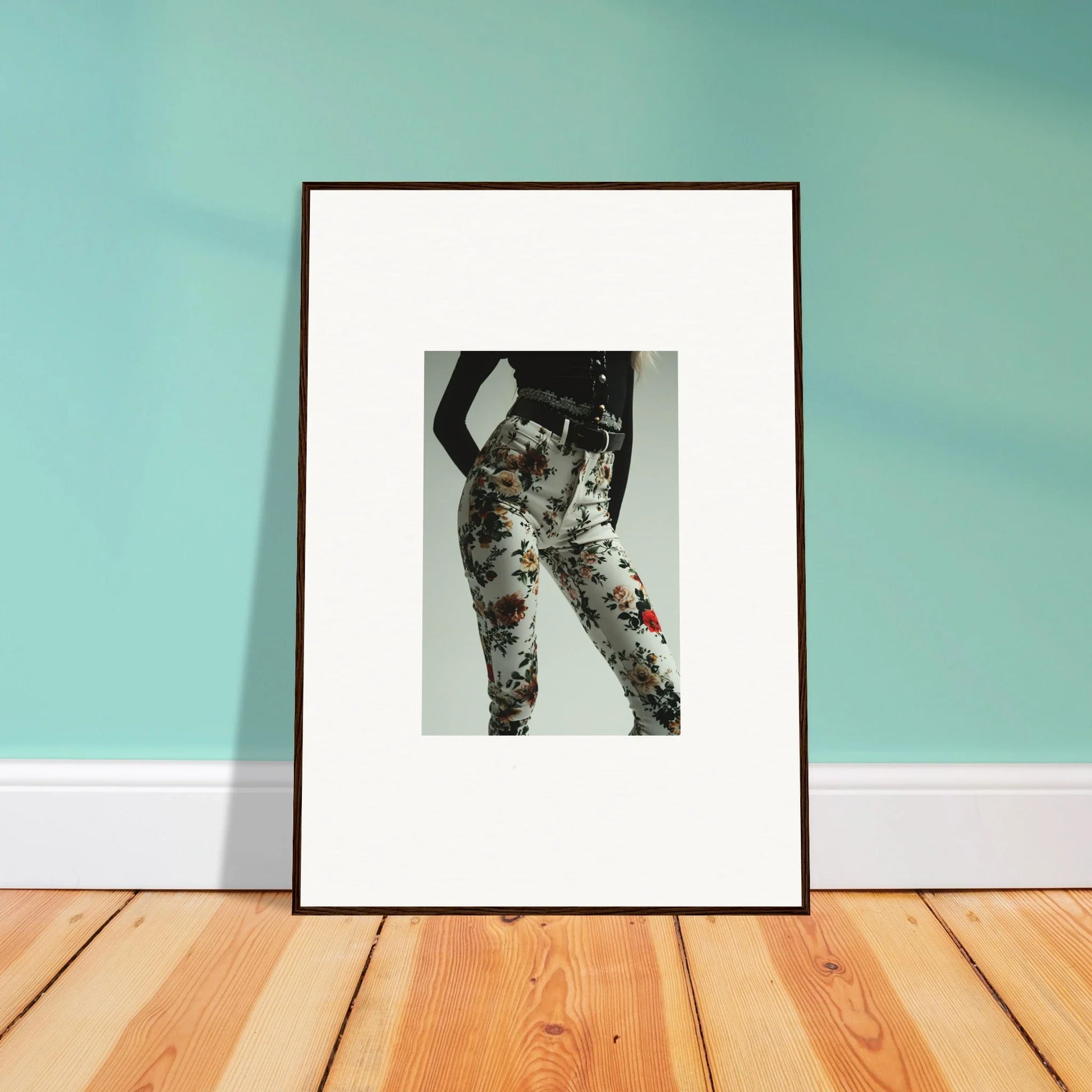 Framed black and white artwork depicting a stylized human figure with floral patterns.