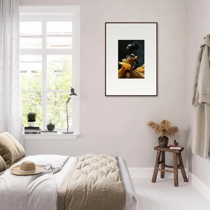 Framed artwork depicting fruit on a dark background hanging on a light-colored wall.