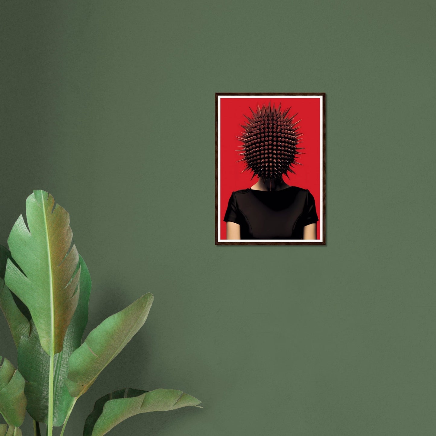 Framed surrealist artwork featuring a figure with a spiky, spherical head against a red background.