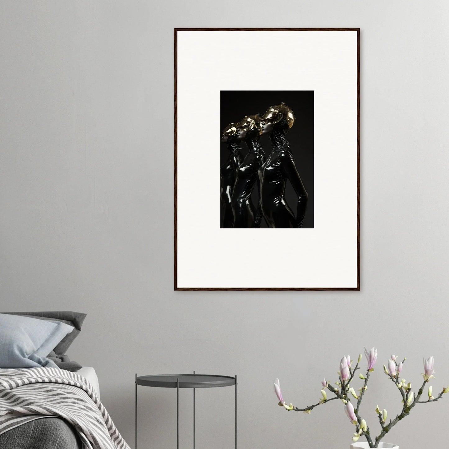 Framed black and white photograph of two shiny metallic figures in a dark, dramatic setting.