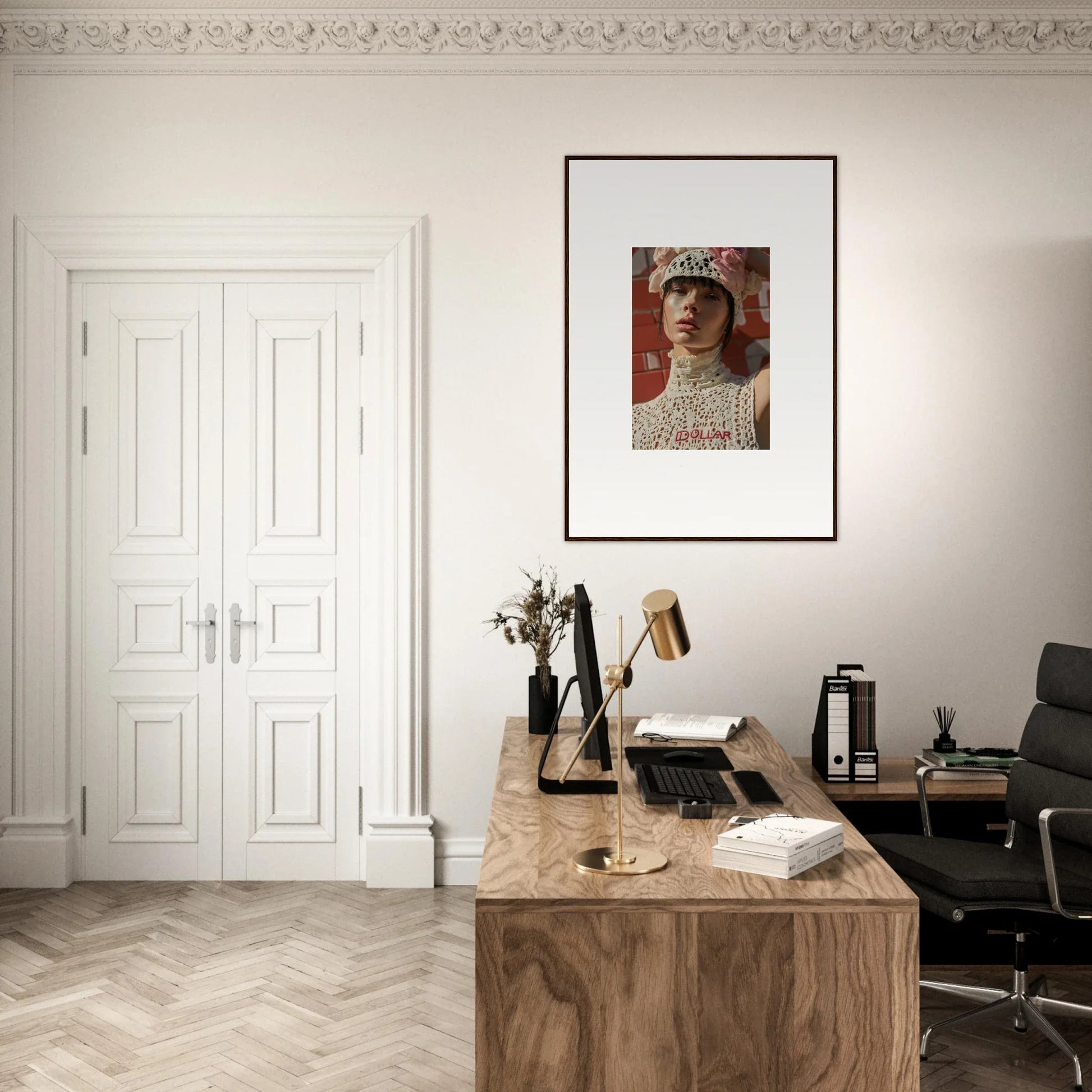 Elegant home office with a wooden desk, framed artwork, and ornate molding.