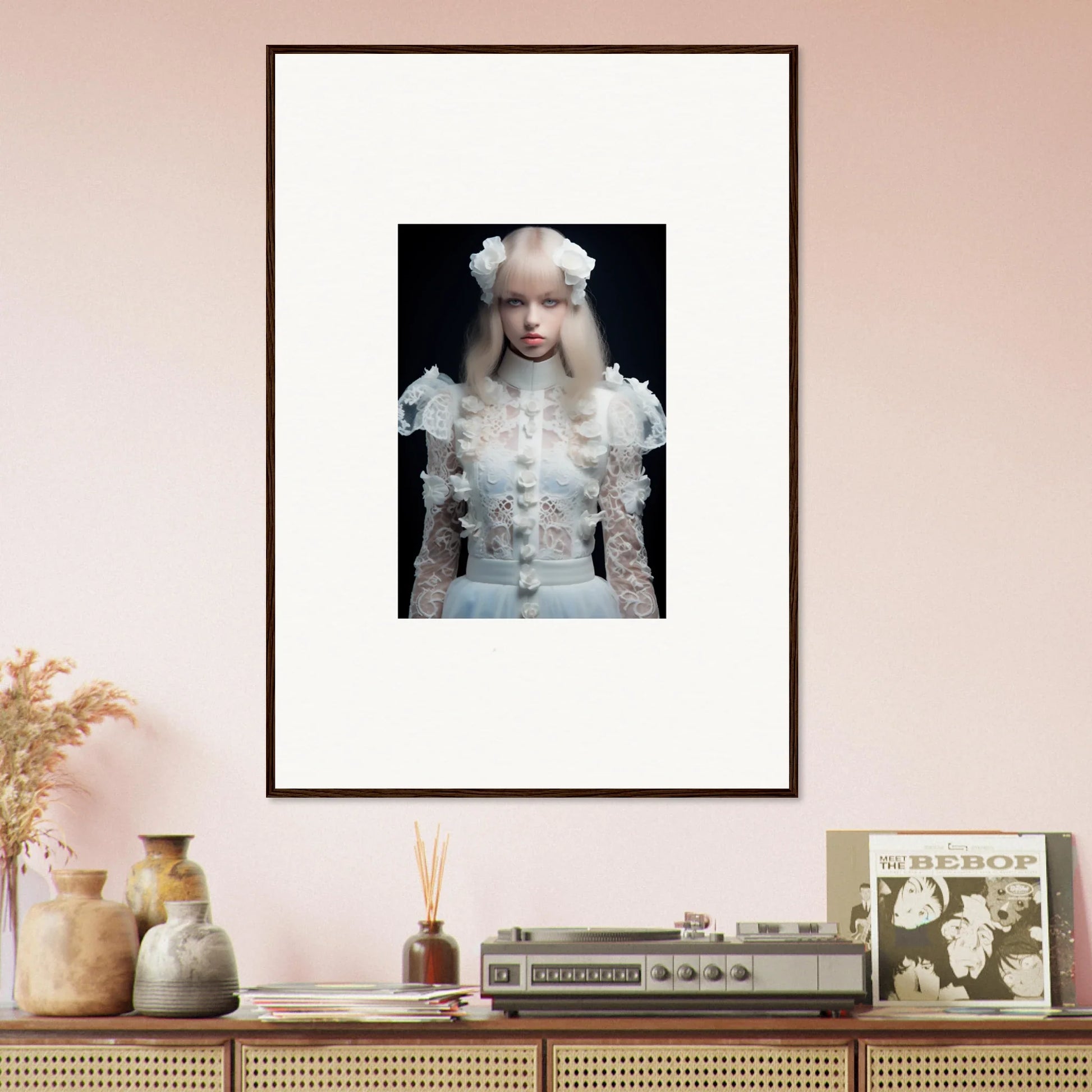 Framed portrait photograph of a person with pale skin and white hair wearing an ornate white outfit against a dark background.