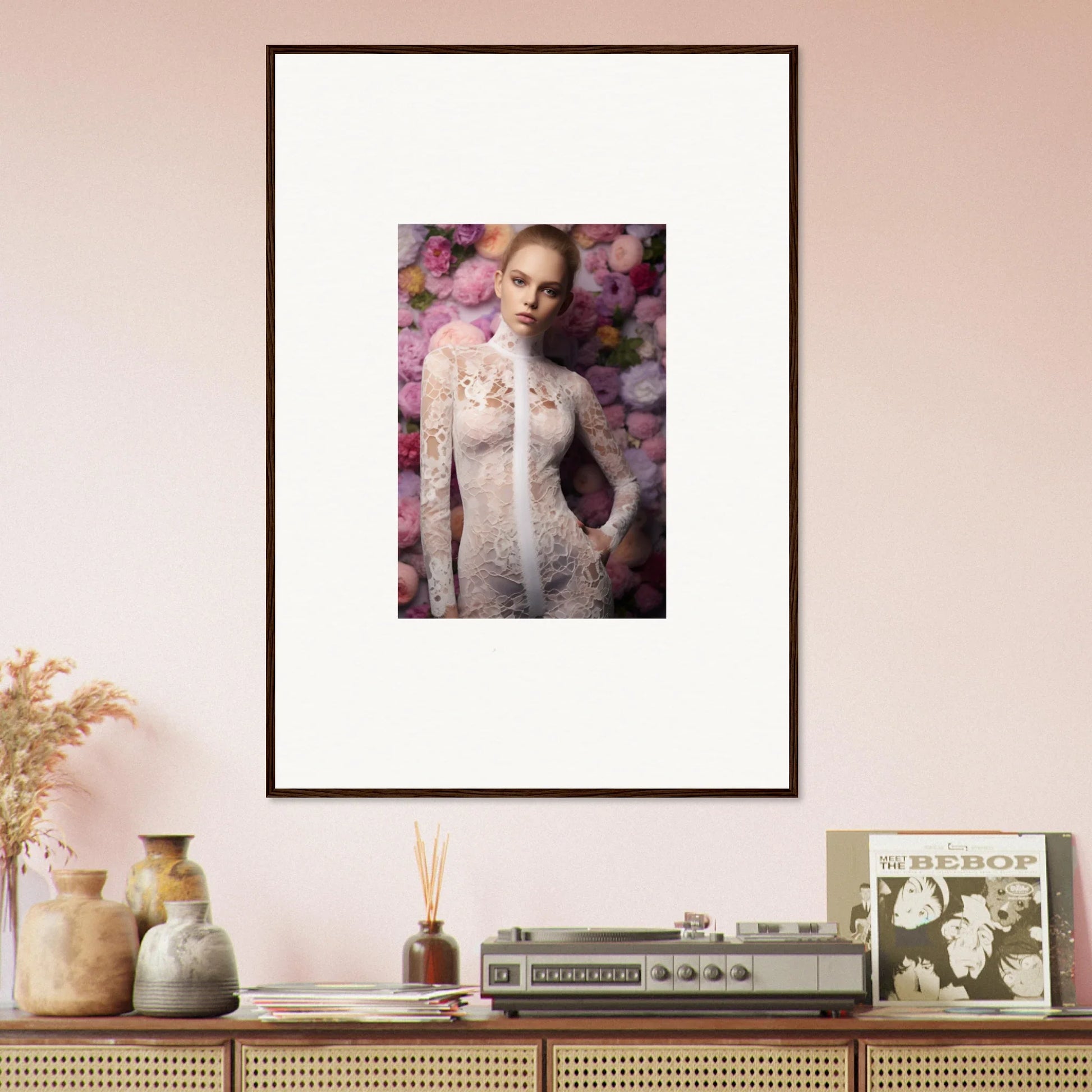 Framed portrait of a woman in a white lace dress surrounded by pink flowers.