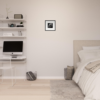 Minimalist bedroom with a bed and floating shelves containing a computer.