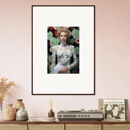 Framed portrait of a woman in a white lace top surrounded by flowers.