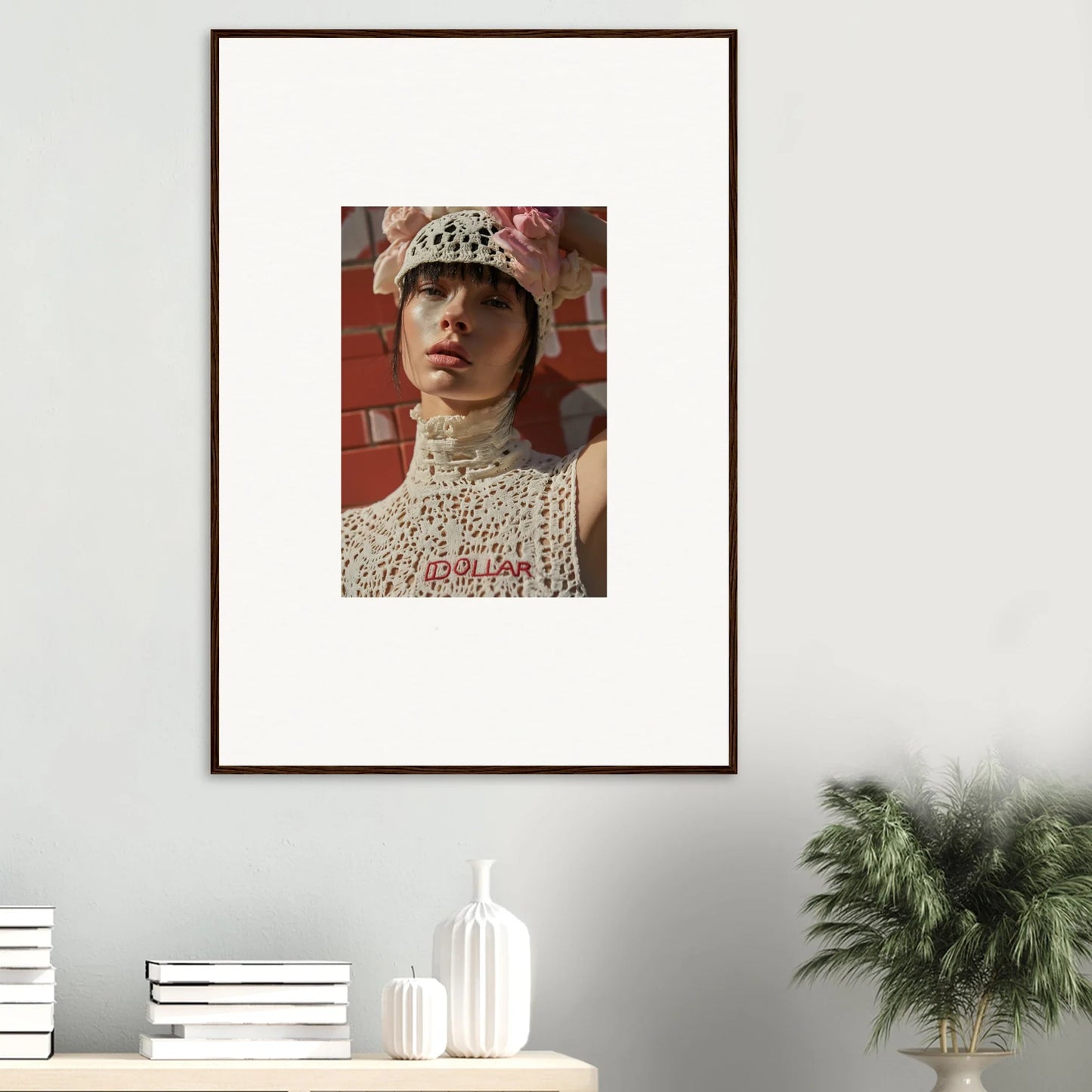 Framed portrait photograph of a person wearing a lacy white outfit and hat.