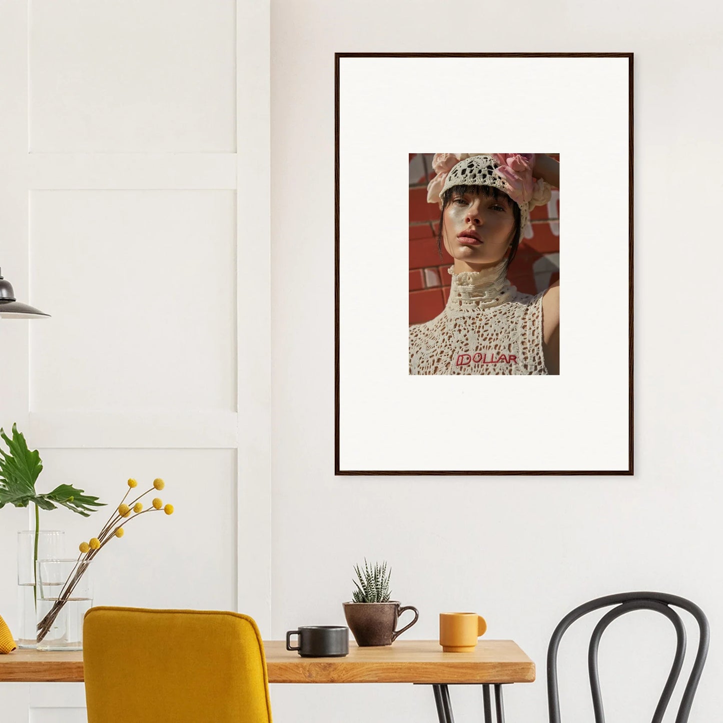 Framed portrait photograph of a person wearing a white hat and lace collar.