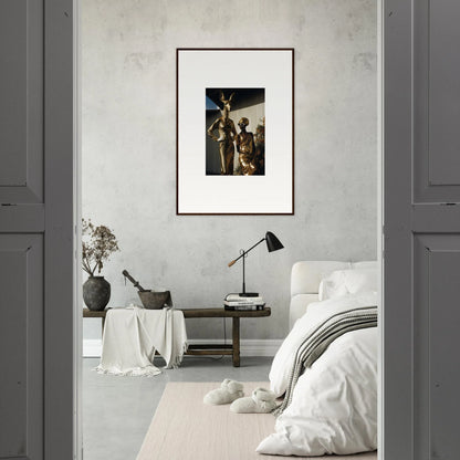 Framed artwork depicting a crucifixion scene hanging on a wall.