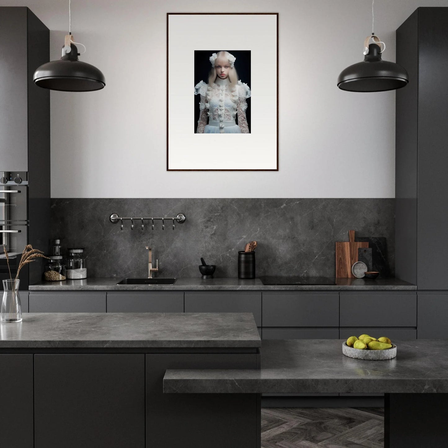 Modern kitchen with dark cabinetry and a framed portrait on the wall.