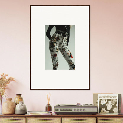 Framed artwork depicting floral-patterned pants or leggings on a person’s lower body.