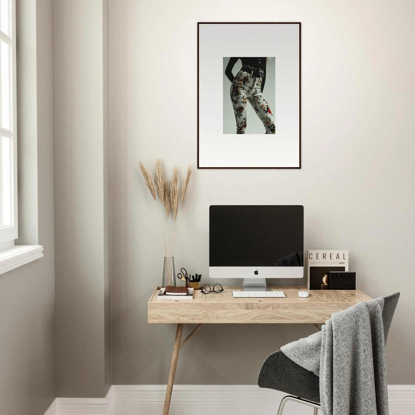 Minimalist wooden desk with a computer monitor and decorative accessories.