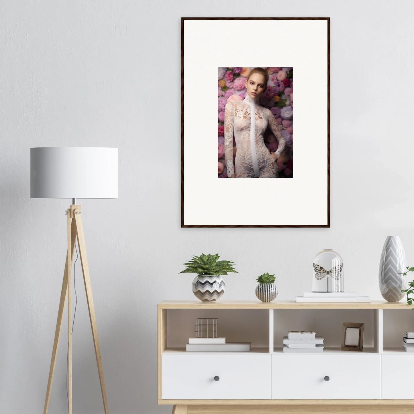 Framed portrait of a woman in a white dress against a floral background.