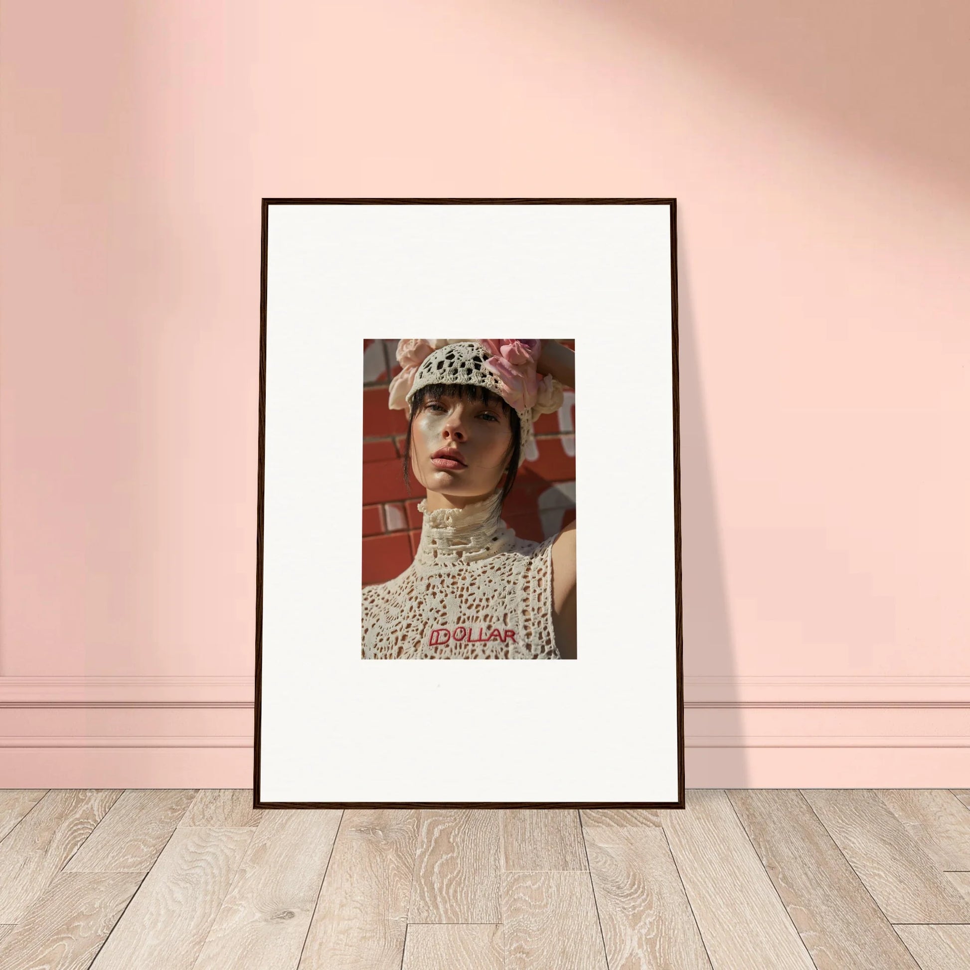 Framed portrait photograph of a person wearing a beaded headpiece and high-necked top.