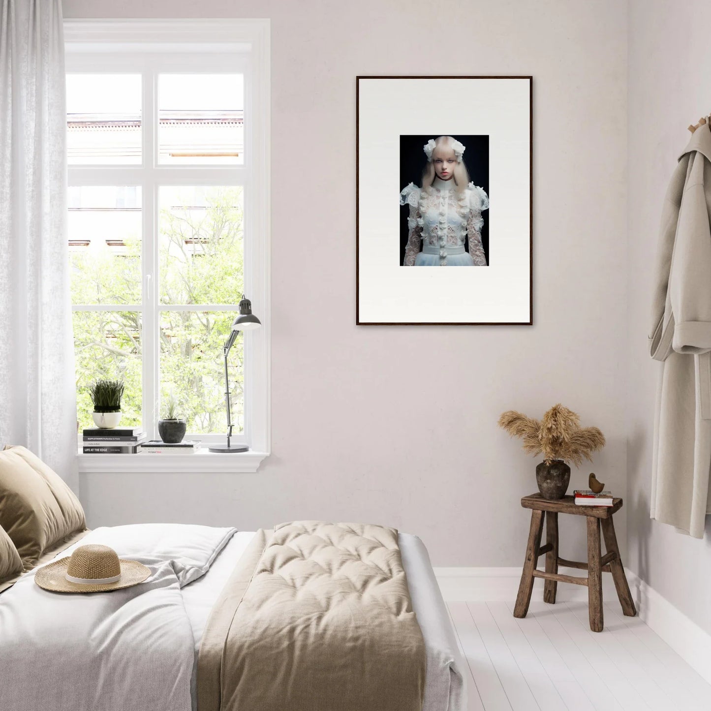 Framed black and white portrait of a person wearing an ornate white outfit.