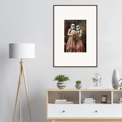 Framed vintage-style photograph of two figures in old-fashioned dresses and hats.