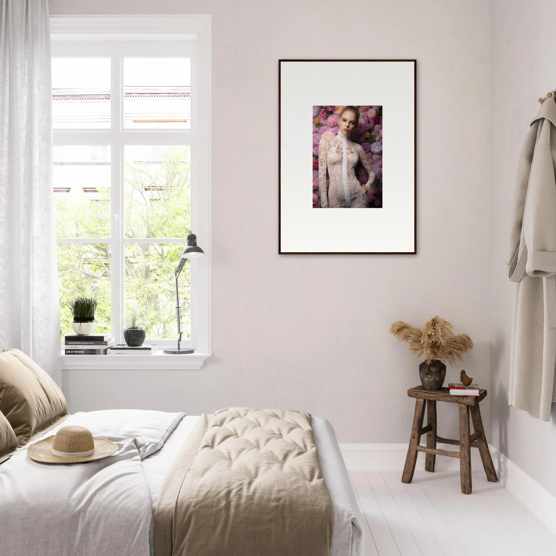 Bright, minimalist bedroom with a framed artistic portrait on the wall.