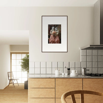 Framed photograph of two figures in vintage clothing hanging on a kitchen wall.