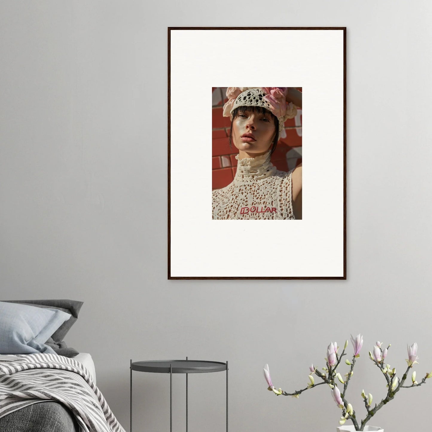 Framed portrait photograph of a person wearing a white lace top and a floral hat.