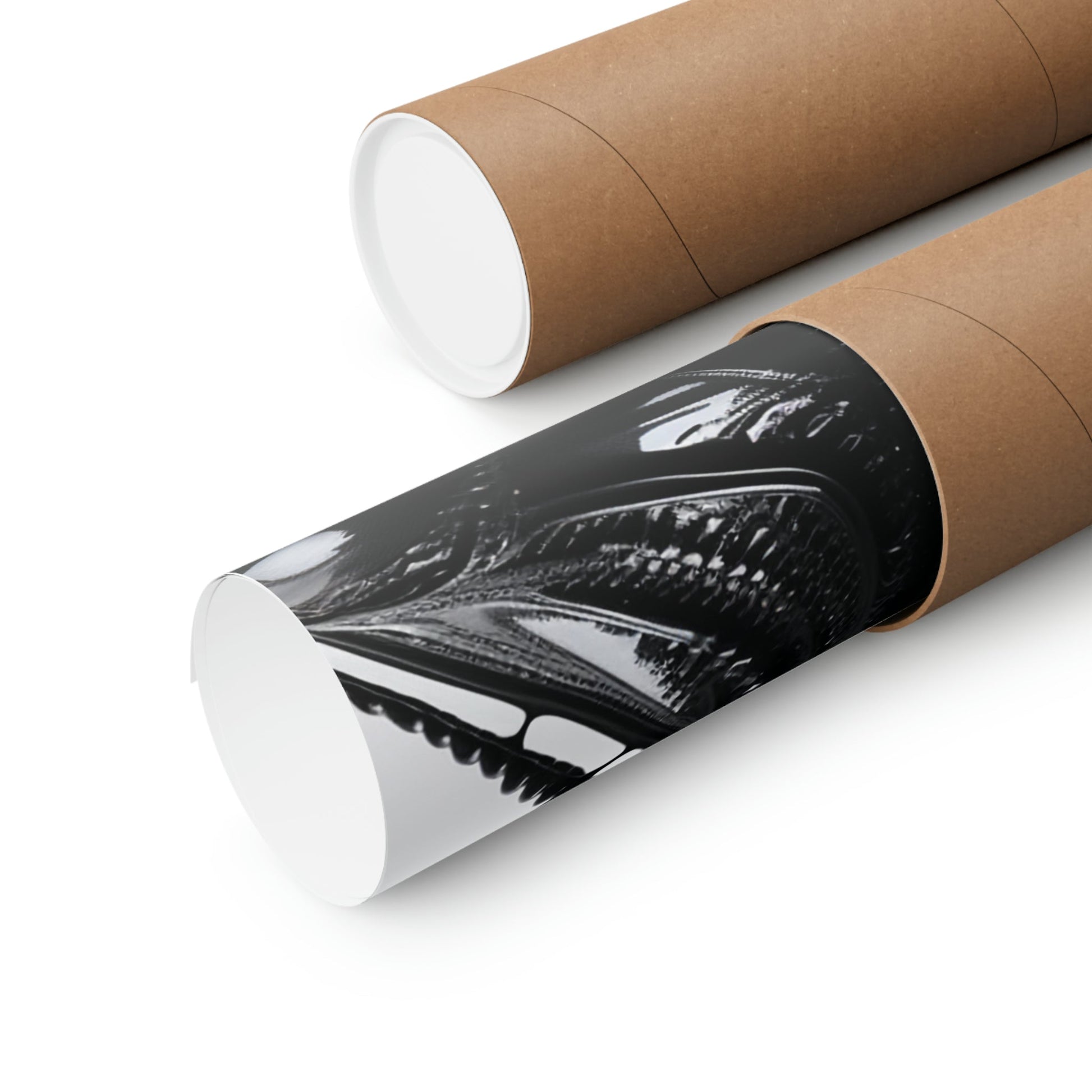 Cardboard mailing tubes, one displaying a black and white graphic design.