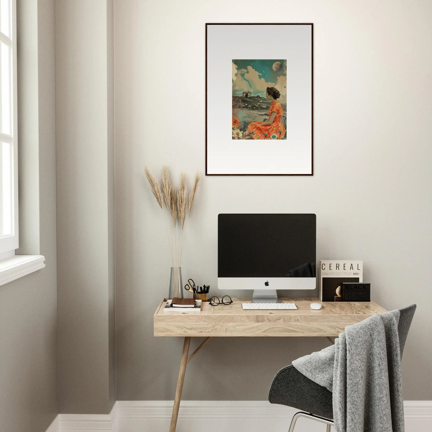 Minimalist wooden desk with a computer and Color Reverie canvas print above it