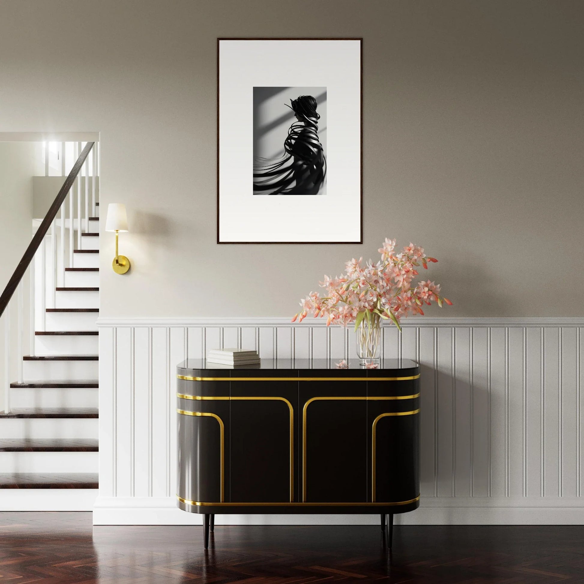 Elegant entryway with black and gold console table, floral decor, and canvas print