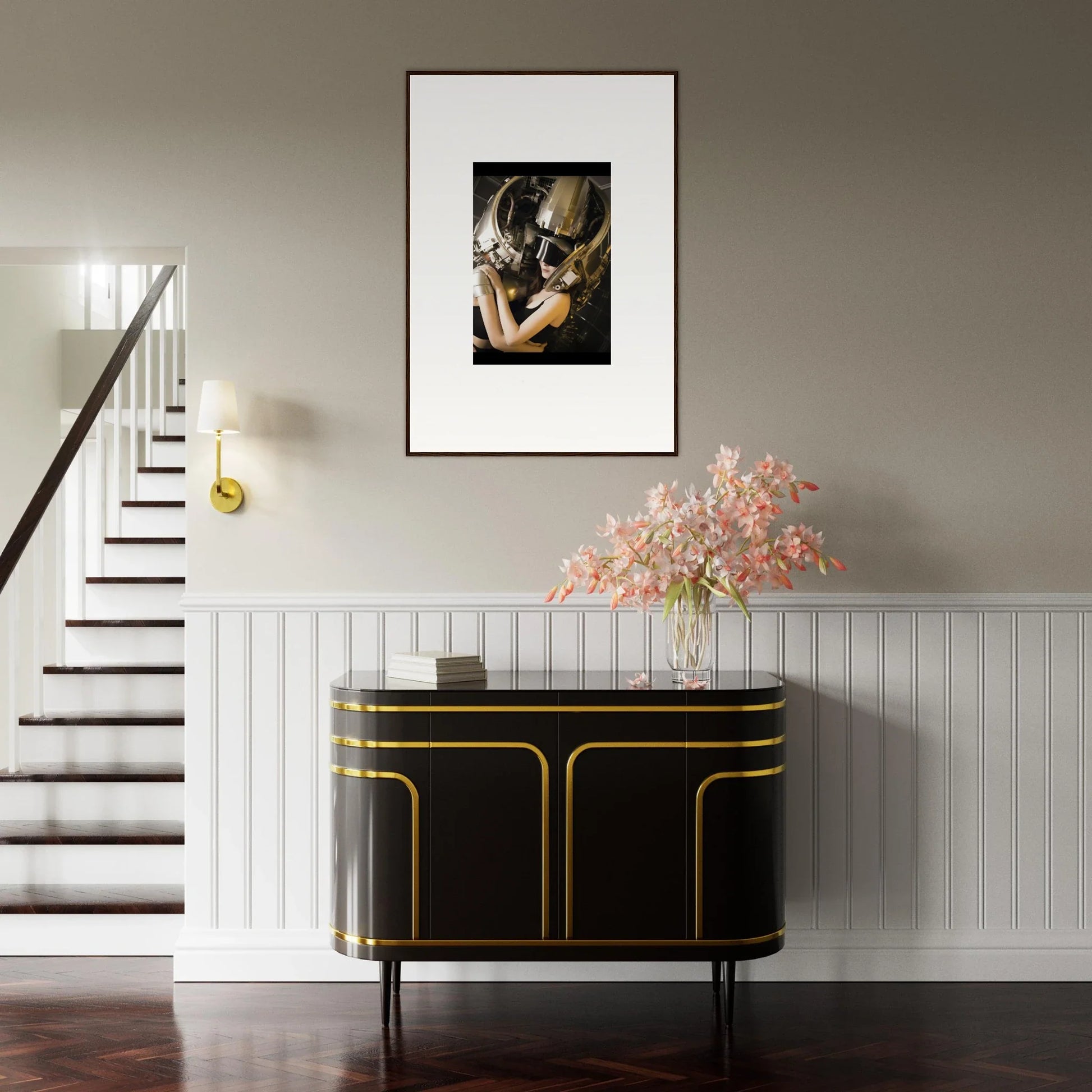 Framed wall art of a close embrace above a chic black and gold sideboard for room decoration