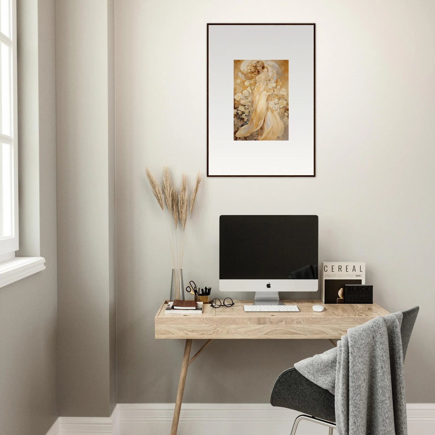 Stylish minimalist wooden desk with a computer and a floral harmony canvas print above